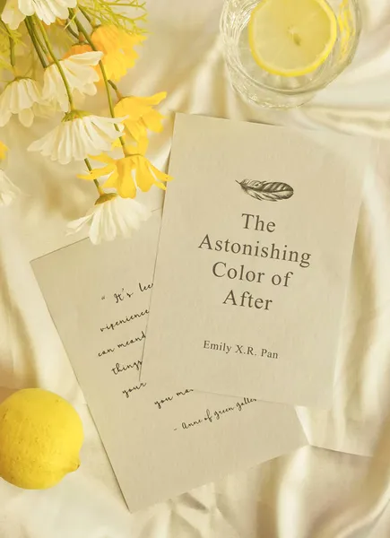 lemon tea with yellow flowers and note book on white background