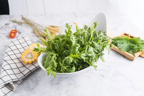 fresh green salad with herbs and greens on white background