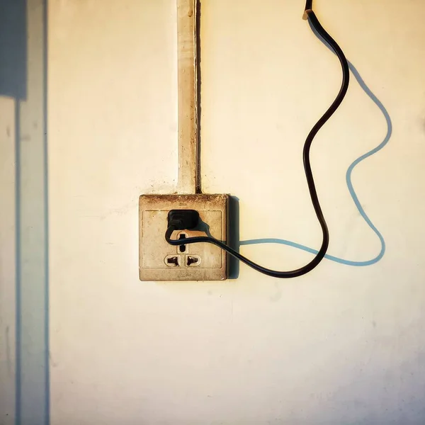 old rusty electric plug on a wall