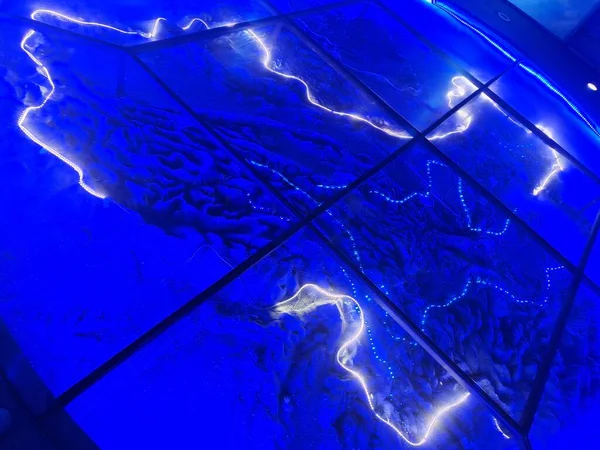 blue water surface with a glass of light