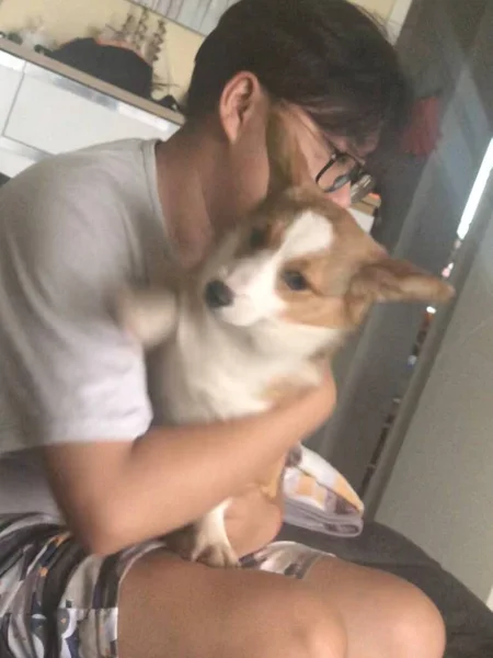 young man with dog in the kitchen