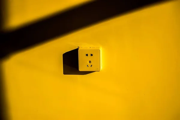 yellow led light switch on a wall