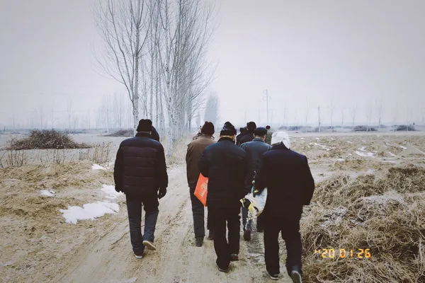 group of people walking in the winter forest