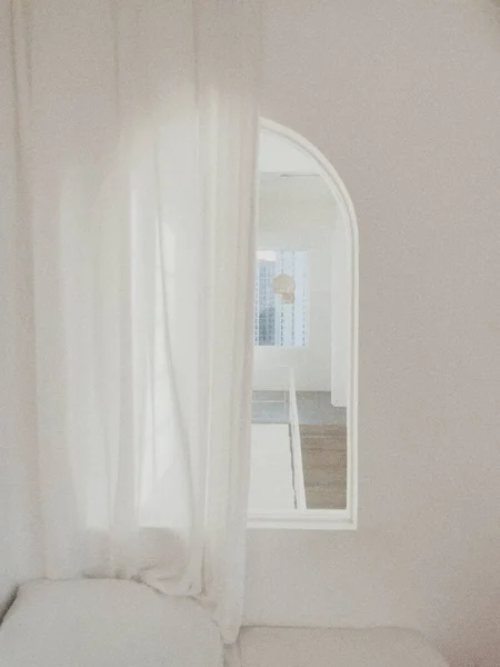 white room interior with window and curtains