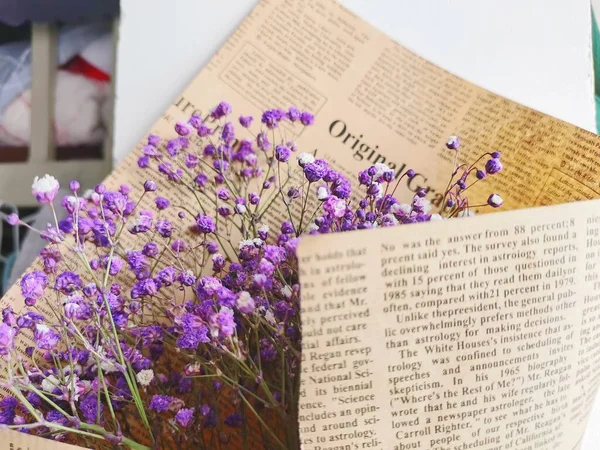 old book with flowers on a background of a wooden table