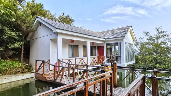 modern house with wooden roof and balcony