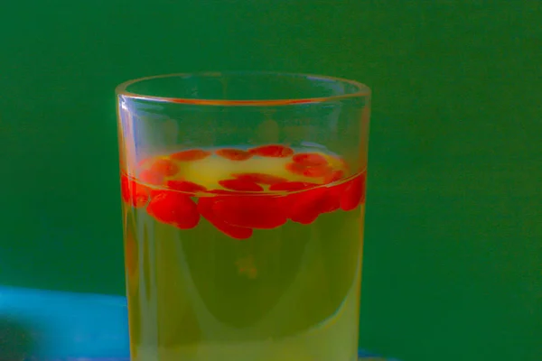 glass of water with lemon and red juice