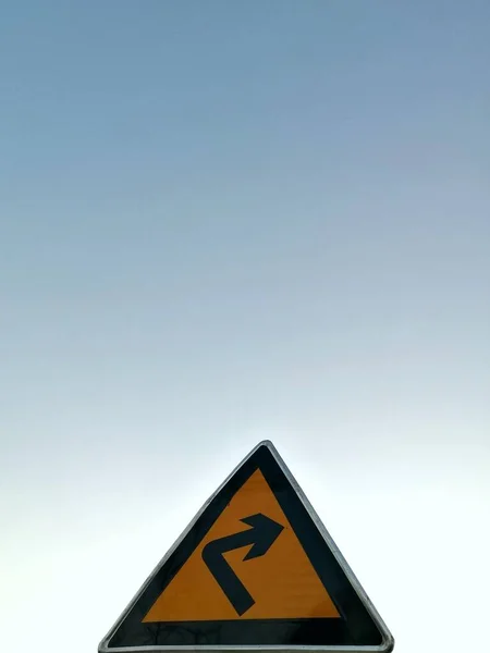 road sign with a warning symbol