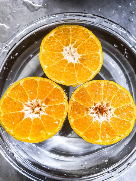orange slices of water with a slice of lemon