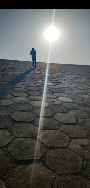 silhouette of a man walking on the street