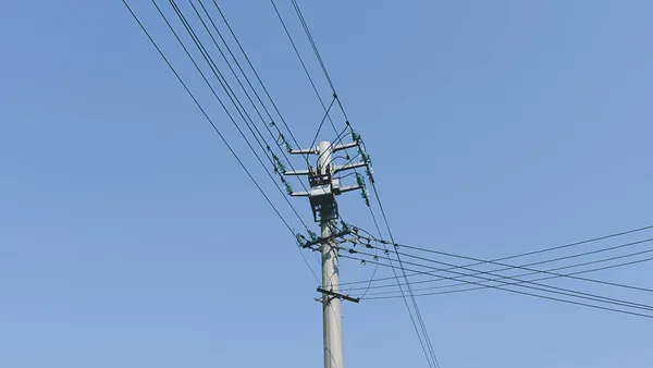 high voltage power line against the blue sky