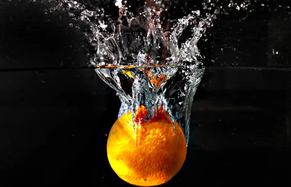 orange water splash on black background