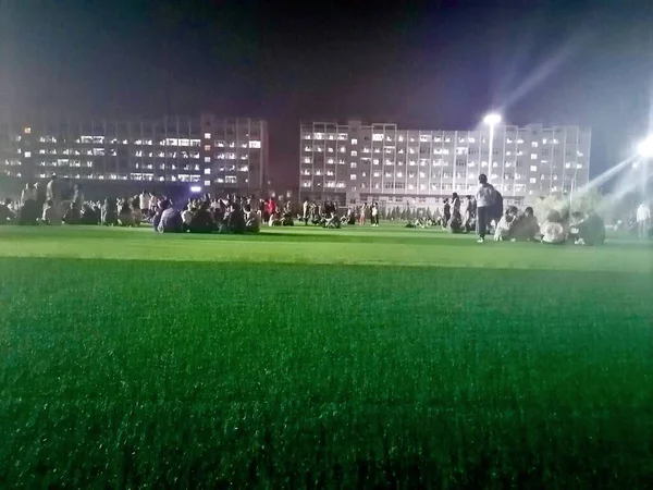 football field with green grass and lights