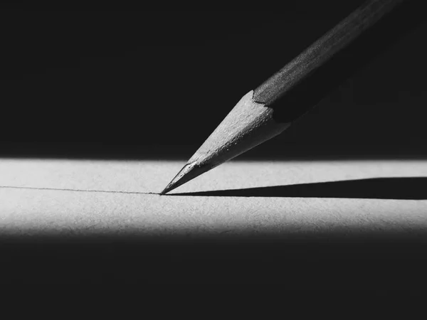 close up of a black pencil on a dark background