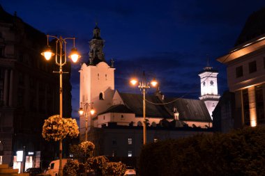 Gece eski şehir merkezi atmosferik yer. Şehir simgesi seyahat noktası, fener ışıkları ve katedral arka plan binası.