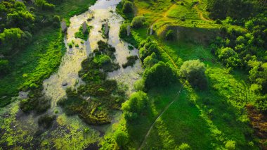 fairy tale beautiful county side landscape morning scenic view of terrain green grass hills and ruins of old bridge under morning sun rise natural light