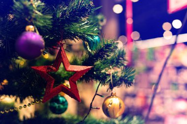 Christmas concept wallpaper decoration star and balls advertising photography with blue toning in mall with bokeh blurred background concept