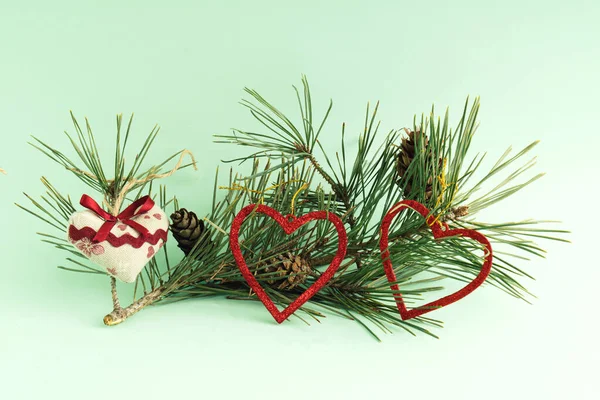 Pine Branch Decorated Cones Hearts Pastel Green Background — Stock Photo, Image