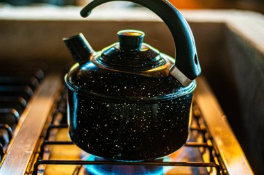 Kettle of water being heated on the stove.