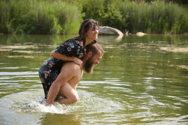 caucasian couple in love having a bath in a lake in France