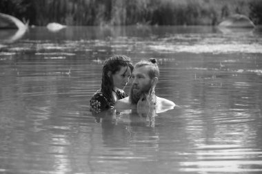 caucasian couple in love having a bath in a lake in France