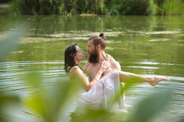 caucasian couple in love having a bath in a lake in France