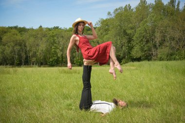 caucasian couple doing stunts on a meadow in France
