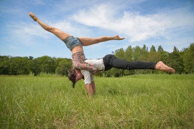 caucasian couple doing stunts on nature in France