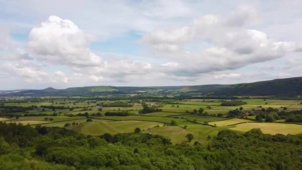 Drone hyperlapse over patchwork fields in North York Moors with clouds — Stock Video