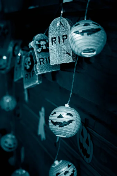 Halloween decorations, pumpkins and graves on a blue background