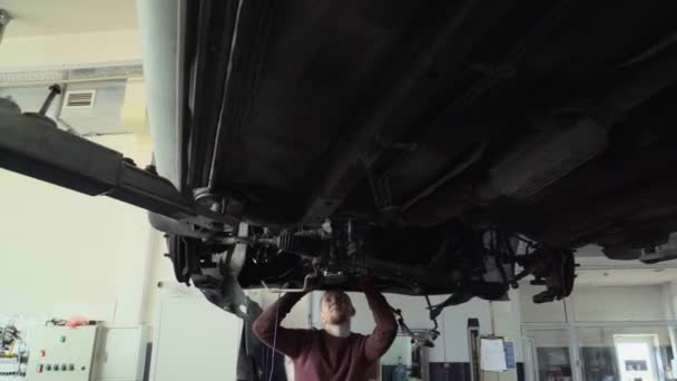 Two Mechanics Repair Suspension Car — Stockvideo