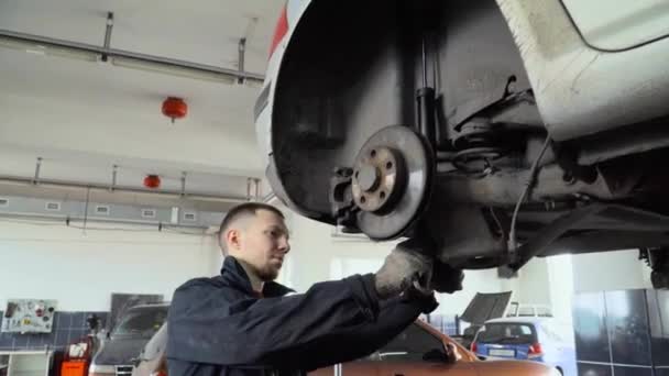 Mechaniker Zieht Die Schraube Des Autos Mit Den Händen Fest — Stockvideo