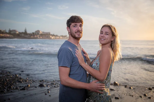Μερικοί Εραστές Στην Παραλία Κατά Διάρκεια Του Ηλιοβασιλέματος Αγκαλιάζονται Και — Φωτογραφία Αρχείου