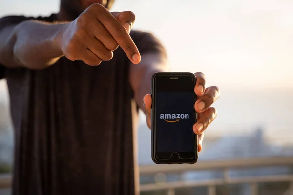 Man Holds Smartphone Amazon Logo American Multinational Technology Company Which — Stock Photo, Image