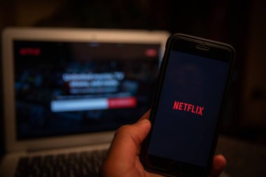 Netflix bir akıllı telefon ve dizüstü bilgisayarın ekranında, Netflix bir Amerikan abonelik yayın hizmeti ve üretim şirketidir..