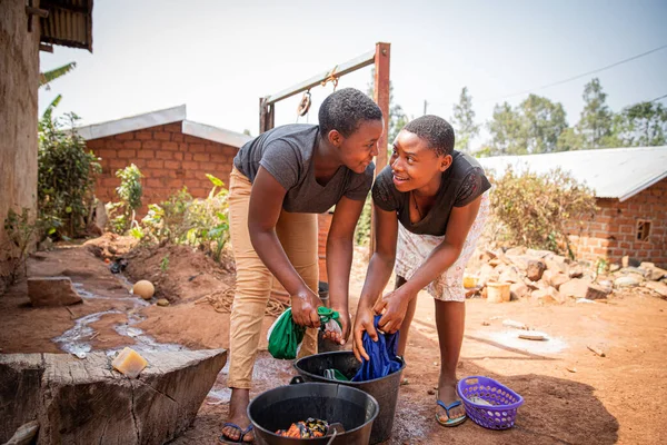 Two African Girls Wash Clothes Hand Using Soap Bucket Traditional — Stock Fotó