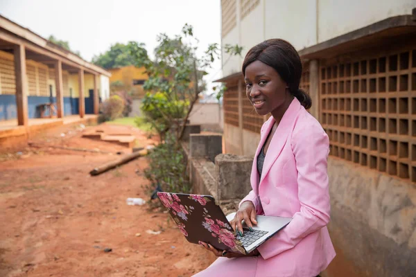 Businesswoman sat uses her laptop and works, women and work in africa