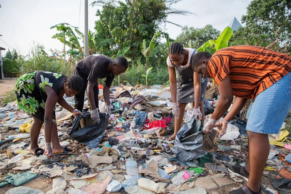 Four Young Adults Collect Garbage Illegal Open Air Landfill Africa — Stok fotoğraf