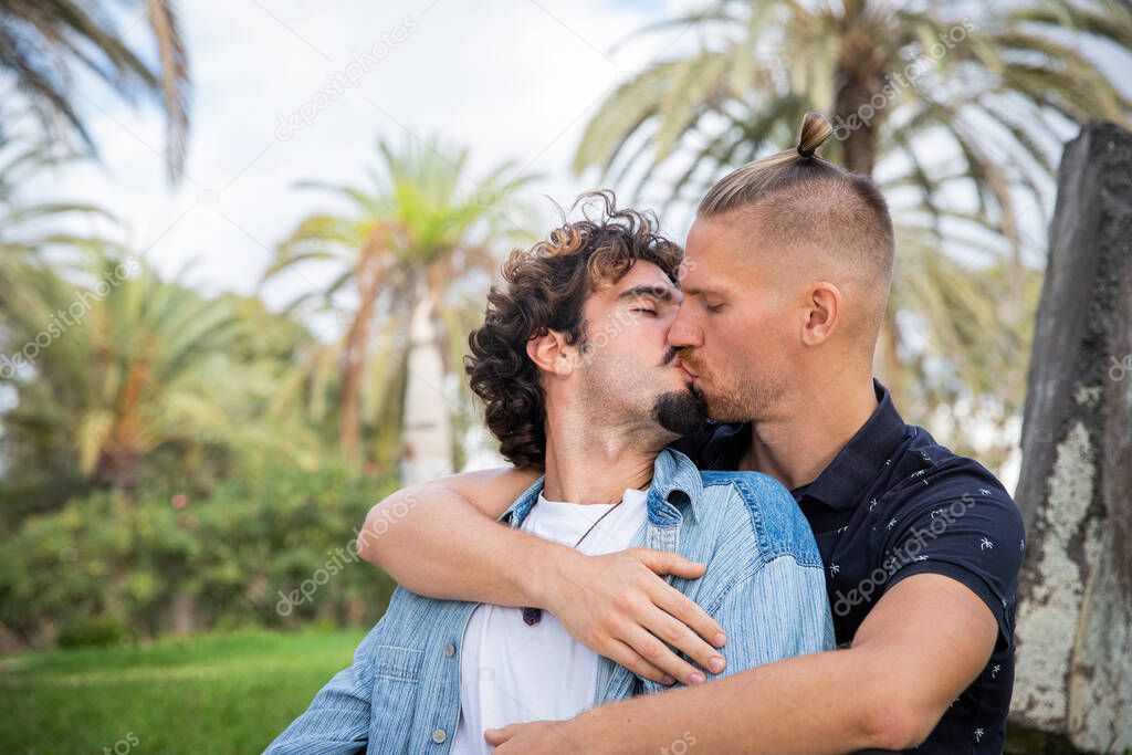 Ttwo boys in love kiss, same sex couple during a passionate moment.