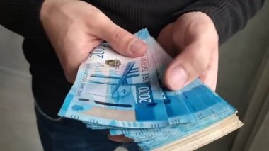 Bir adam eline para fanatiği alır.