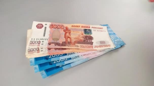 Rosyjskie pieniądze pięć tysięcy dolarów banknoty rzucać na stół z wentylatorem. — Wideo stockowe