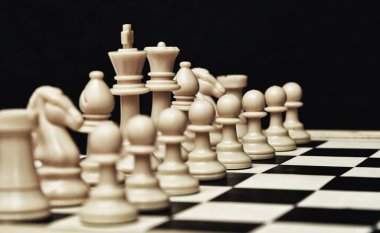 Oyun tahtasında beyaz satranç figürü