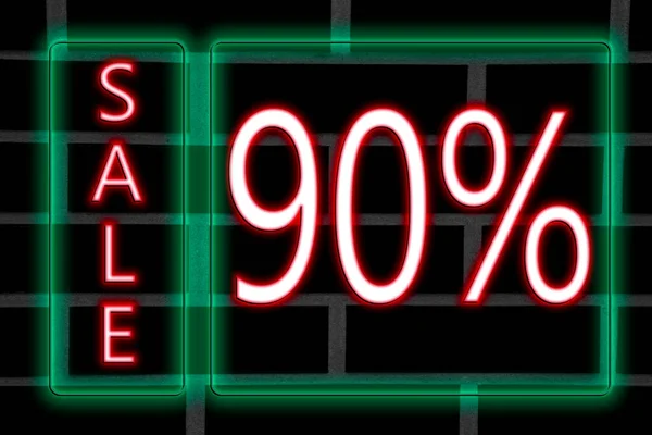 Pink neon inscription 90 percent discount in green neon frame on brick wall background