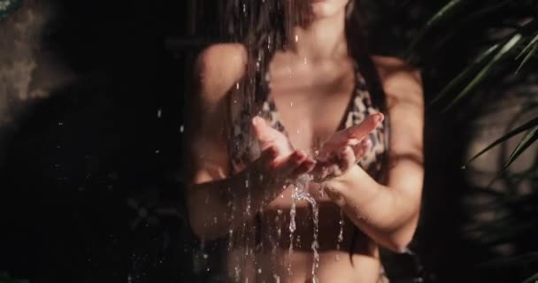 Women hands catching drops of water from exotic shower, slow motion — Stock Video