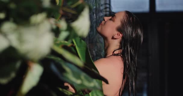 Woman in bikini washing body under tropical shower, slow motion — Stockvideo