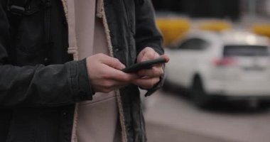 Şehirdeki erkeklerin elinde akıllı telefon var.