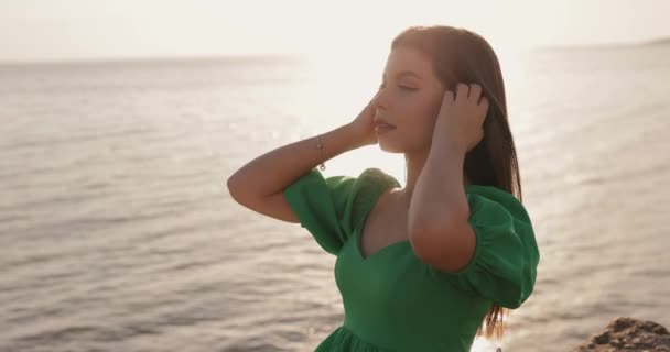 Young Woman Green Dress Looking Sea Sunset Sitting Hill Slow — Stockvideo