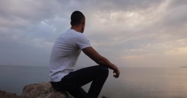 Dramatic sky, man looking at the clouds thinking about future of his life