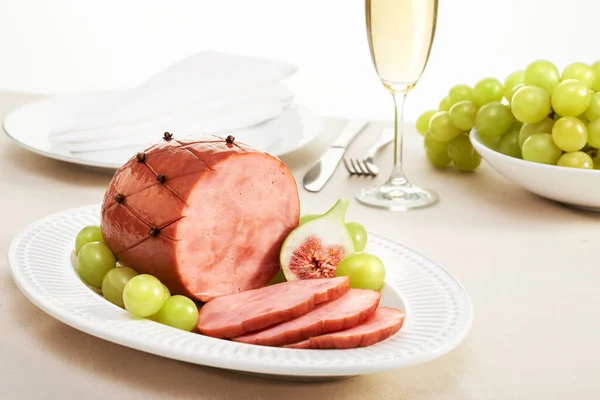 wine, ham and grapes on white plate