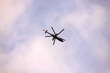Baku, Azerbaijan. 01.26.2021. Flying helicopter on a cloudy sky.